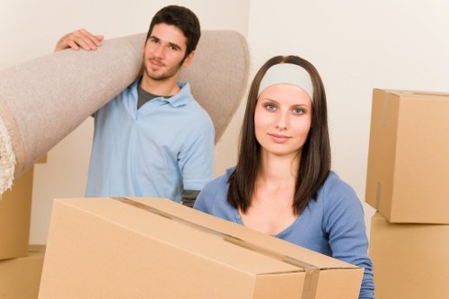 Packed moving boxes and secured furniture for transport